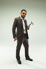 Image showing The barded man in a suit holding cane.