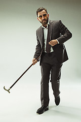 Image showing The barded man in a suit holding cane.