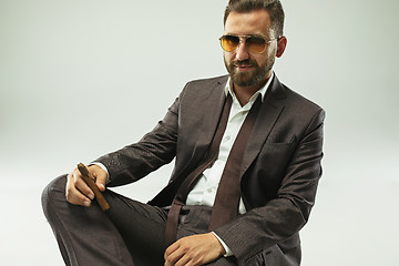 Image showing The barded man in a suit holding cigar