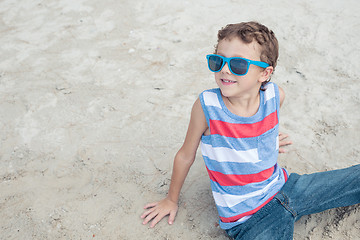 Image showing One happy little boy playing on the beach at the day time.