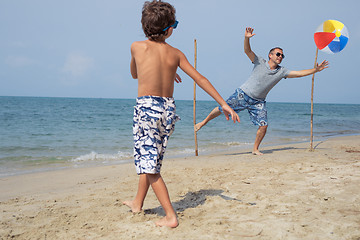 Image showing Father and son playing football on the beach