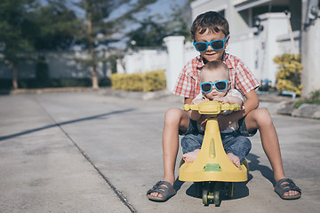 Image showing Two happy little children playing on the road at the day time.