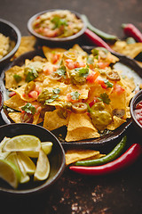 Image showing Tasty mexican nachos chips served on ceramic plate