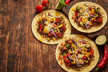 Image showing Healthy corn tortillas with grilled beef, fresh hot peppers, cheese, tomatoes