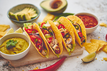 Image showing Tasty Mexican meat tacos served with various vegetables and salsa