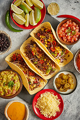 Image showing Tasty Mexican meat tacos served with various vegetables and salsa