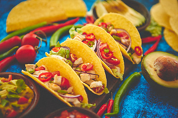 Image showing Mexican taco with chicken meat, jalapeno, fresh vegetables served with guacamole