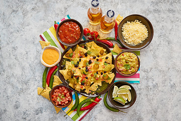 Image showing Mexican corn nacho spicy chips served with melted cheese