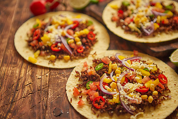 Image showing Healthy corn tortillas with grilled beef, fresh hot peppers, cheese, tomatoes