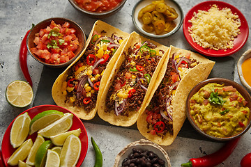 Image showing Tasty Mexican meat tacos served with various vegetables and salsa