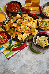 Image showing Mexican nachos tortilla chips with black bean, jalapeno, guacamole