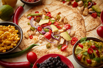 Image showing Freshly made healthy corn tortillas with grilled chicken fillet, big avocado slices