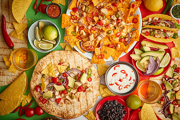 Image showing An overhead photo of an assortment of many different Mexican foods on a table