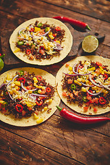 Image showing Healthy corn tortillas with grilled beef, fresh hot peppers, cheese, tomatoes