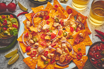 Image showing Mexican corn nacho spicy chips served with melted cheese