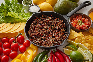 Image showing Ingredients for Chili con carne in frying iron pan on white wooden table