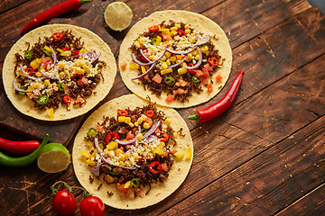 Image showing Healthy corn tortillas with grilled beef, fresh hot peppers, cheese, tomatoes