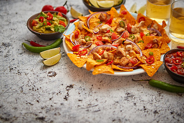 Image showing Mexican corn nacho spicy chips served with melted cheese