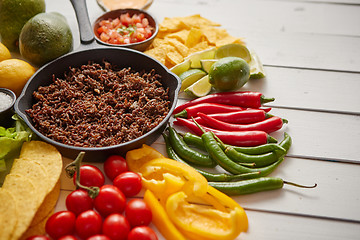 Image showing Ingredients for Chili con carne in frying iron pan on white wooden table