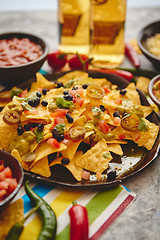 Image showing Mexican corn nacho spicy chips served with melted cheese