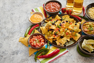 Image showing Mexican nachos tortilla chips with black bean, jalapeno, guacamole