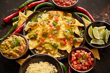 Image showing Fresh yellow corn nacho chips on ceramic plate