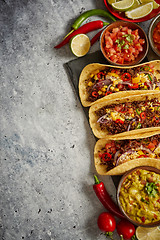 Image showing Tasty Mexican meat tacos served with various vegetables and salsa