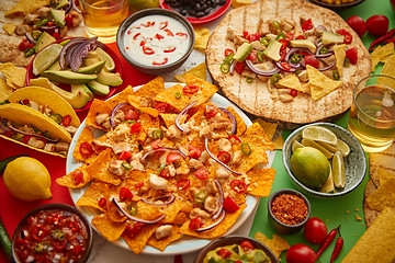 Image showing Various freshly made Mexican foods assortment. Placed on colorful table