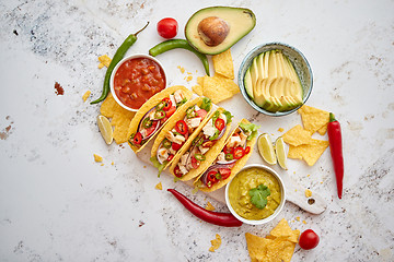 Image showing Tasty Mexican meat tacos served with various vegetables and salsa