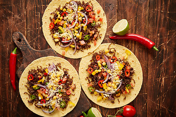 Image showing Healthy corn tortillas with grilled beef, fresh hot peppers, cheese, tomatoes