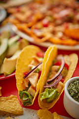 Image showing Close up on crispy tacos with various freshly made Mexican foods assortment