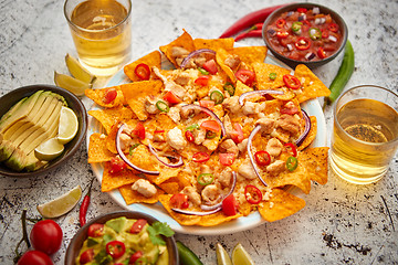 Image showing Mexican corn nacho spicy chips served with melted cheese