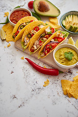 Image showing Tasty Mexican meat tacos served with various vegetables and salsa