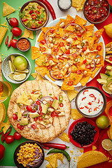 Image showing An overhead photo of an assortment of many different Mexican foods on a table