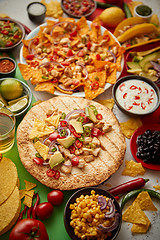 Image showing Various freshly made Mexican foods assortment. Placed on colorful table