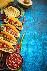 Image showing Mexican taco with chicken meat, jalapeno, fresh vegetables served with guacamole