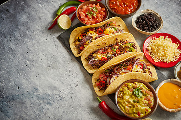 Image showing Tasty Mexican meat tacos served with various vegetables and salsa