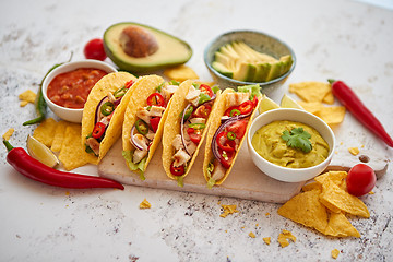 Image showing Tasty Mexican meat tacos served with various vegetables and salsa