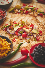 Image showing Freshly made healthy corn tortillas with grilled chicken fillet, big avocado slices