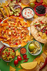 Image showing An overhead photo of an assortment of many different Mexican foods on a table