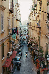 Image showing Alleyway with motorbike driving among old houses in Naples, Italy