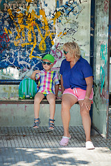 Image showing Multicolor beach people at a bus stop
