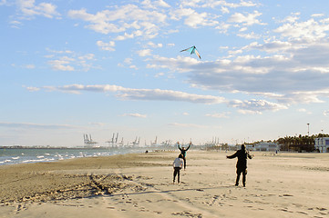 Image showing Flying a kite on the beach