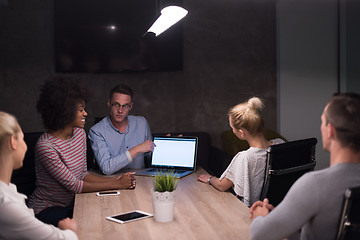 Image showing Multiethnic startup business team in night office