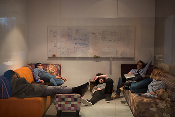 Image showing software developers sleeping on sofa in creative startup office