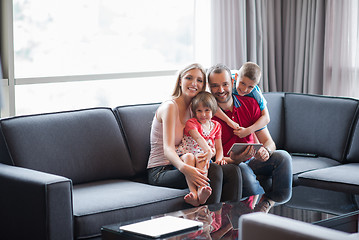 Image showing happy young couple spending time with kids