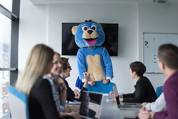 Image showing boss dresed as bear having fun with business people in trendy of