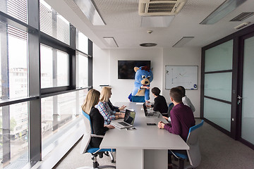 Image showing boss dresed as bear having fun with business people in trendy of