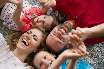 Image showing happy family lying on the floor