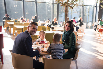 Image showing Young parents enjoying lunch time with their children